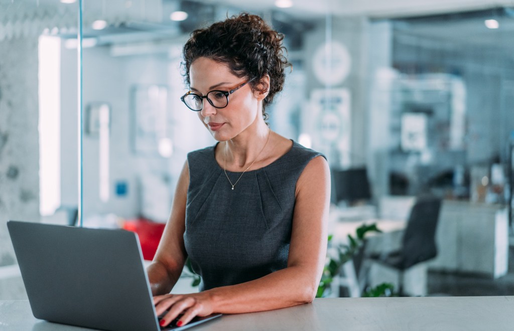 A woman reviewing the pros and cons of accepting phantom equity.