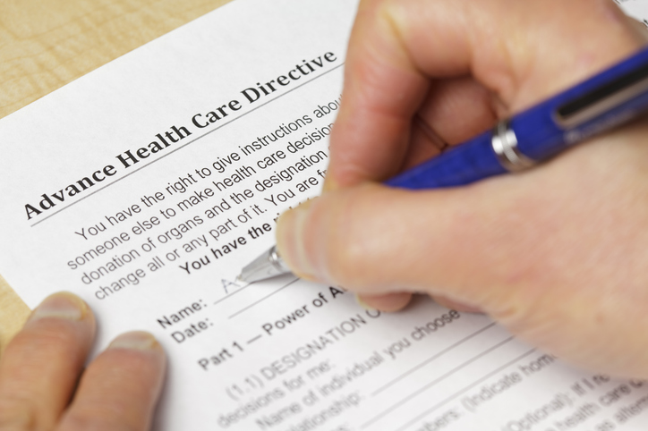 A person filling out a form for an advance healthcare directive in their state.