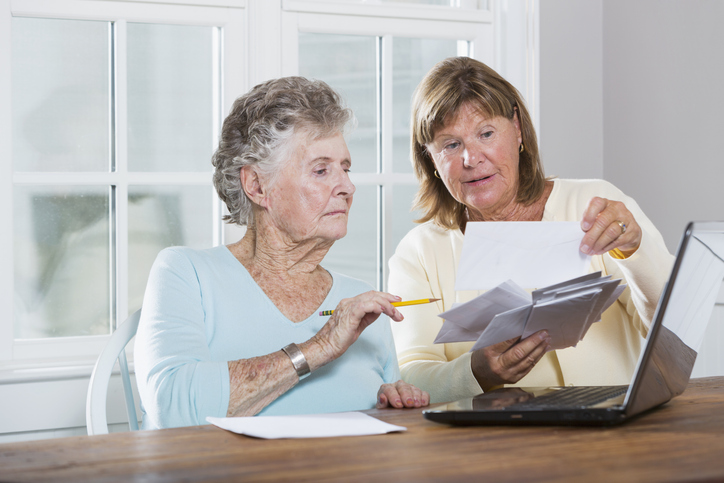 A senior reviewing her Social Security survivor benefits with her daughter.