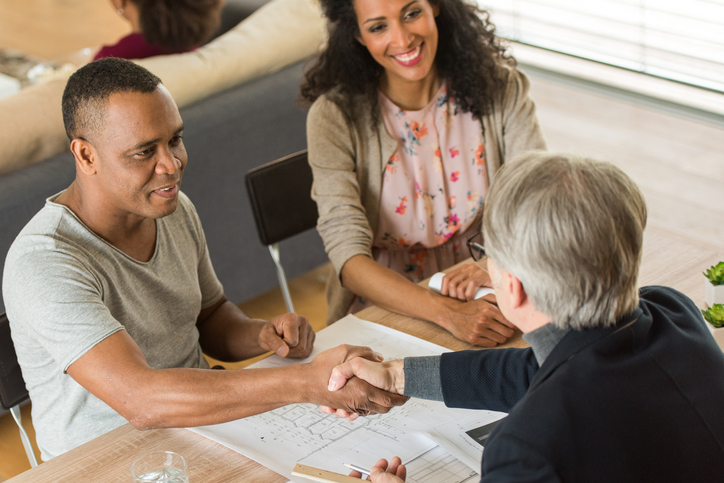 A couple meeting with an advisor to create an estate plan.
