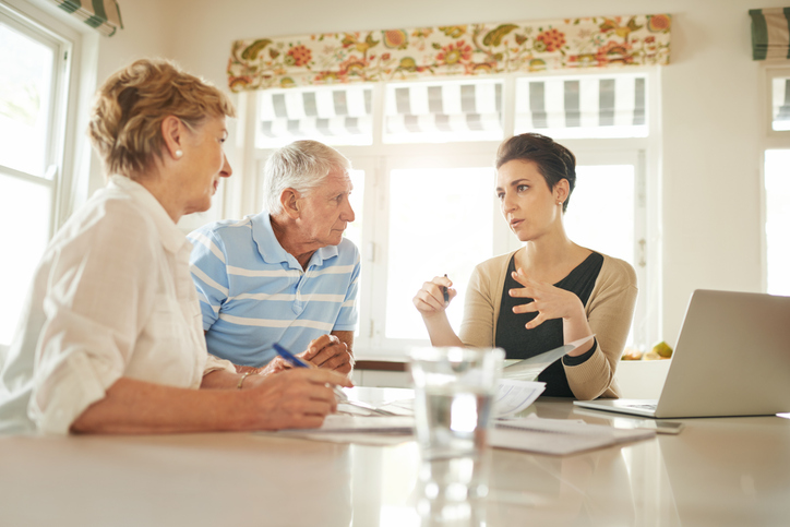 A senior couple getting estate planning advice from an advisor.