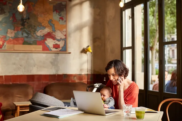 A mom creating a family trust with her  infant sitting on her lap.