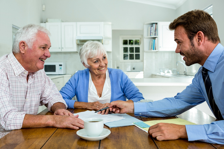 A senior couple meeting with an advisor to create an estate plan.