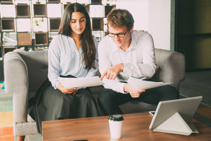 A couple researching ways to invest in real estate without being a landlord.