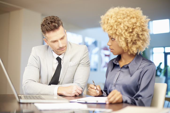 An investor reviewing his real estate portfolio with an advisor.