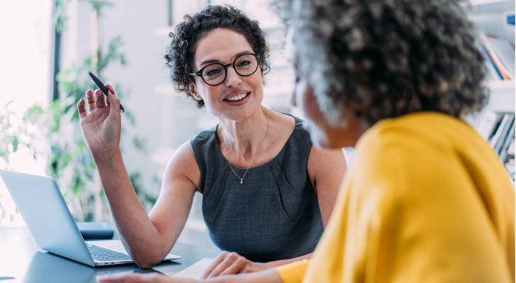 A financial advisor meets with a client and provides a portfolio update.