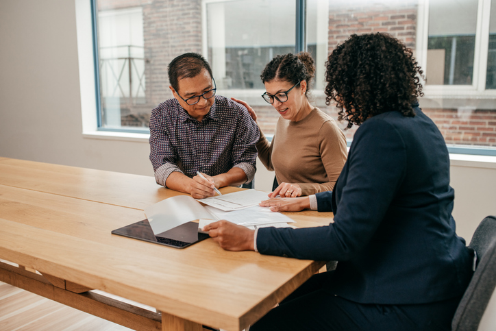 A financial advisor reviewing mid-cap stocks with clients.