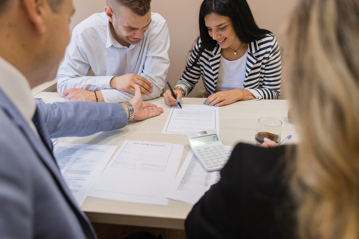 A couple updating documents with a financial advisor for their financial plan.