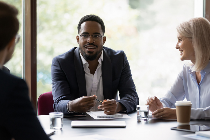A couple discussing their finances with an advisor.