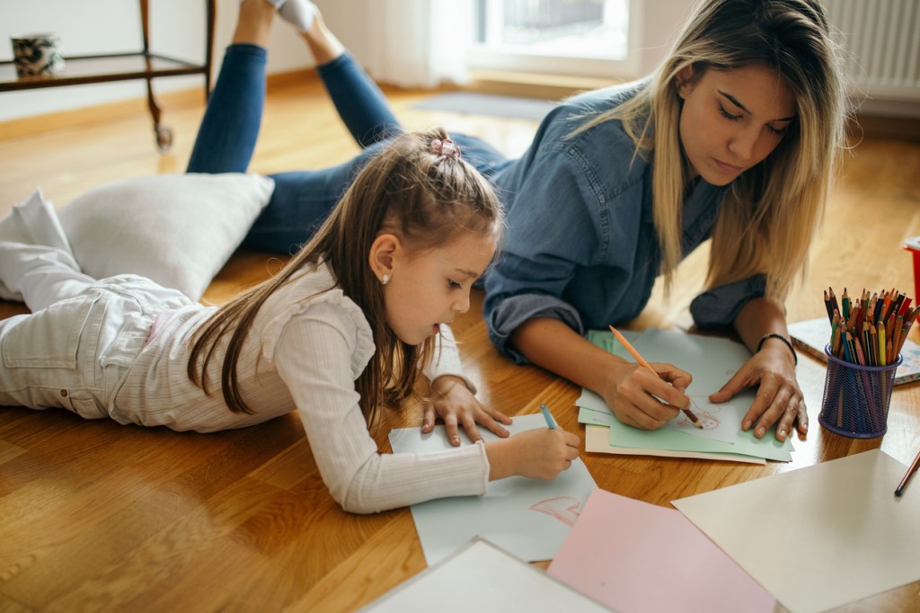 A nanny participating in educational activities with a girl.