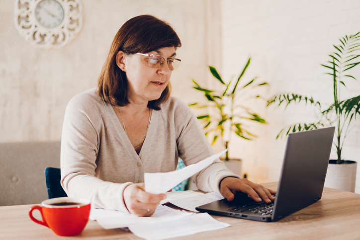 A woman calculating probate costs in North Dakota.