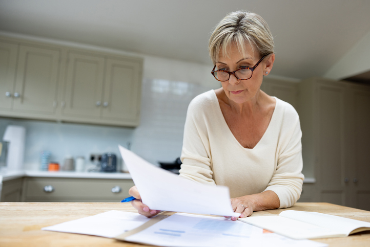 A woman reviewing documents for her retirement plan.
