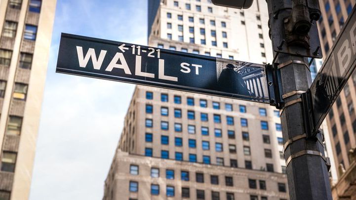 A close-up of a sign for Wall Street in Lower Manhattan.