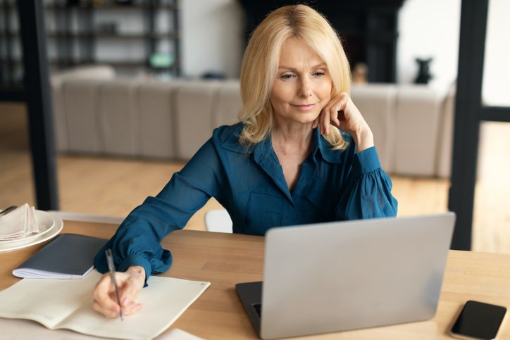 A business woman creating a due diligence checklist for the purchase of a business.