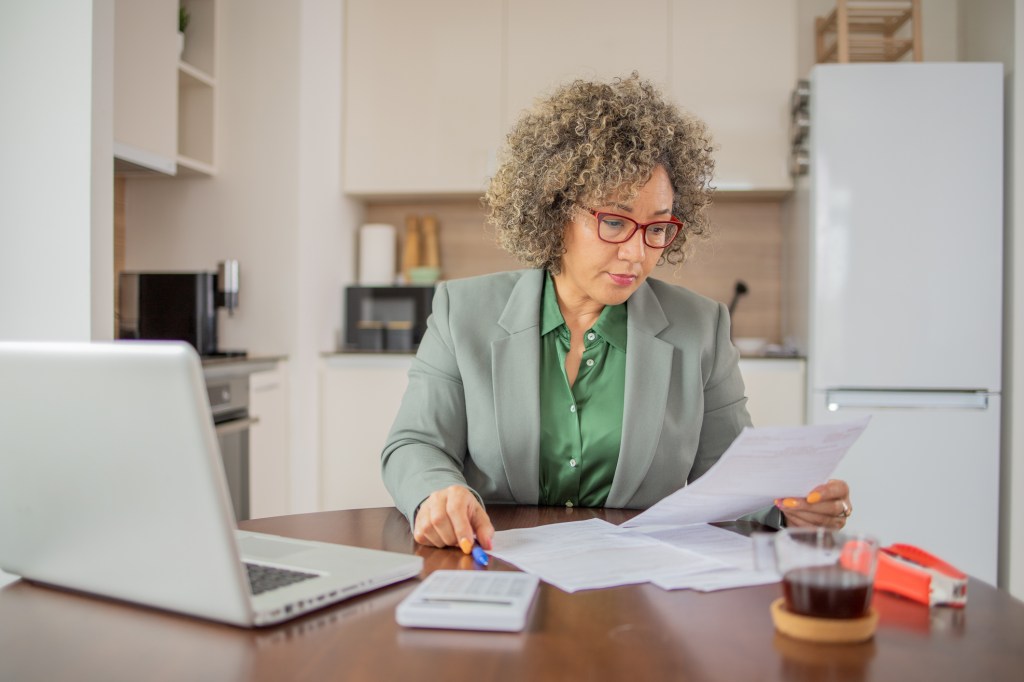 A woman reviewing paperwork to update her estate plan.