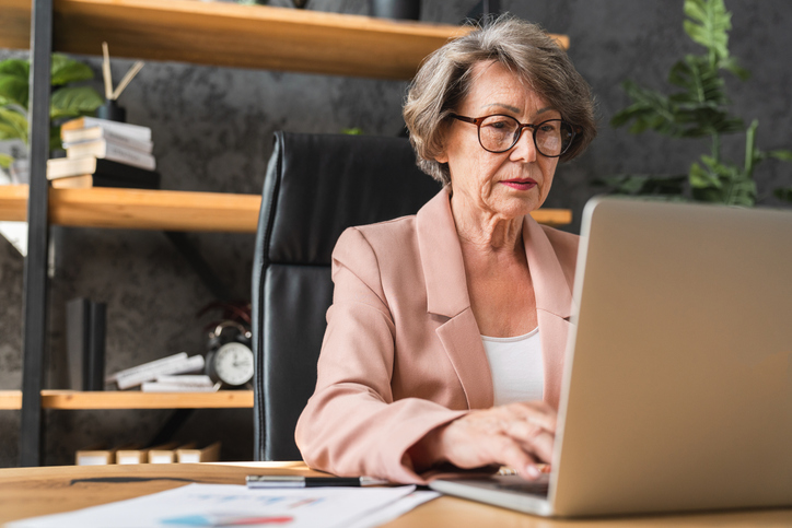 A woman looking up compensation fees for her retirement plan.