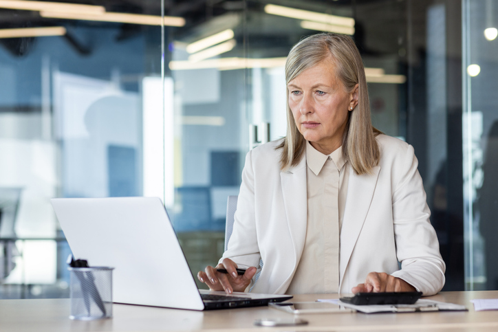 A government worker calculating KDC program costs.