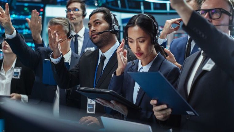 Professional traders working on the floor of a stock exchange.