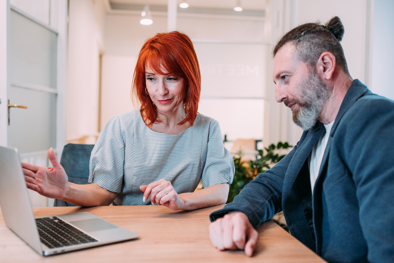 Two real estate investors reviewing a commercial real estate due diligence checklist.