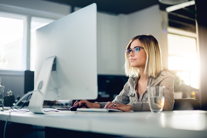 A woman looking up the pros and cons of investing in zero coupon bonds.