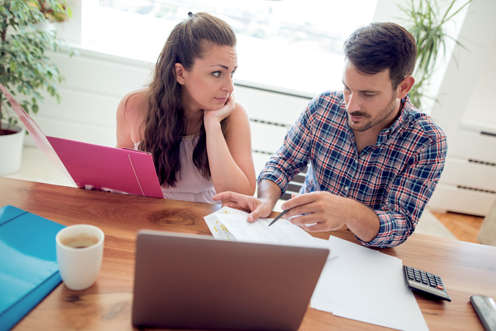 A couple researching how to set an investment objective for their portfolio.