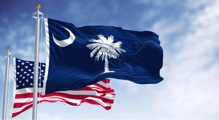 The state flag of South Carolina flies alongside the American flag.