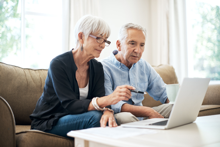 A couple researches the pros and cons of I Bond investments.