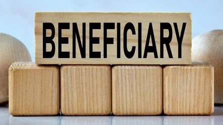 The word "beneficiary" spelled out on a wooden block.