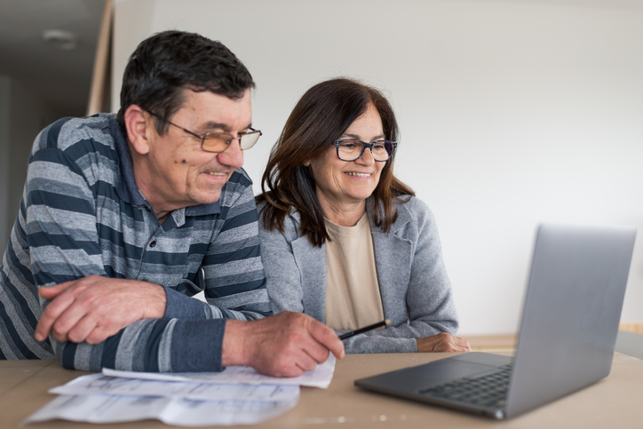 A senior couple reviewing their tax plan.