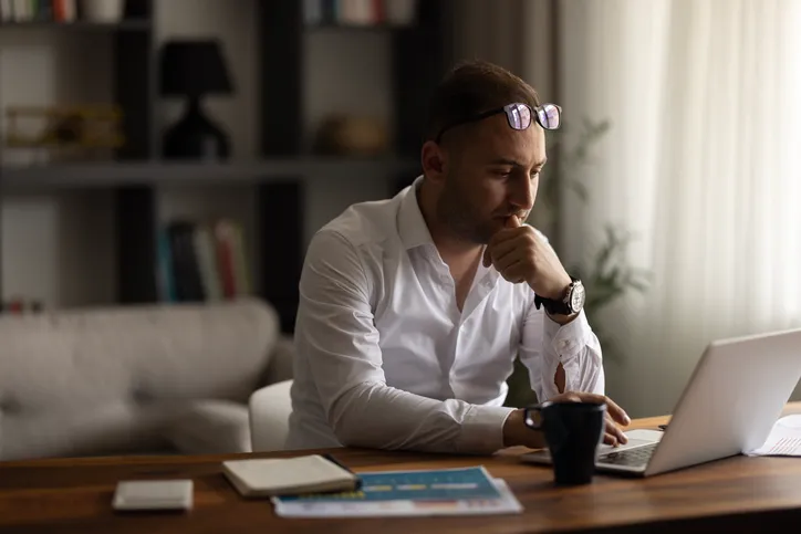A man looking up the differences between yield maintenance and defeasance.