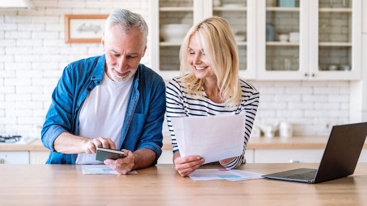 A man and woman manage their household budget together.