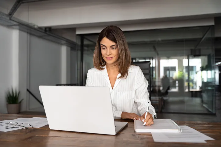 A woman calculating the reserve ratio for a bank.