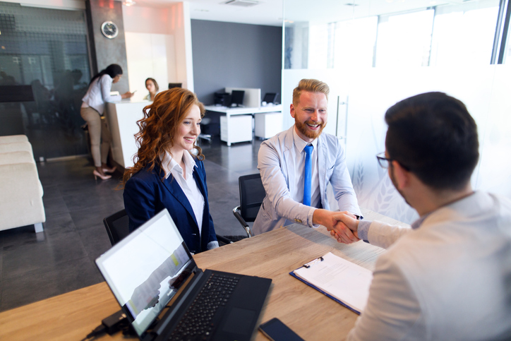 A couple discussing loan terms at a bank.