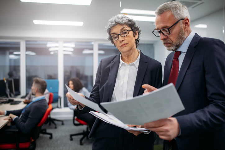 Financial advisors reviewing examples of RegTech applications for their firm.