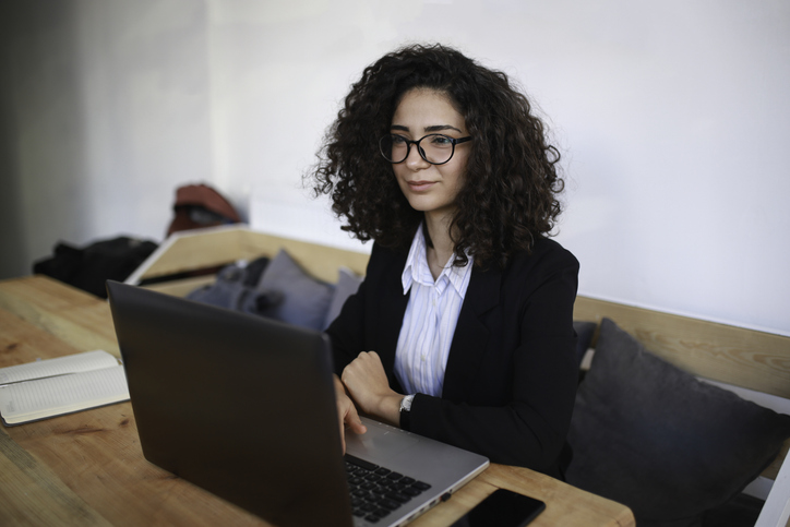 An investor researches the pros and cons of active trading vs. buy-and-hold investing.