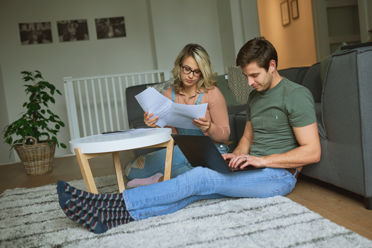 A couple reviewing documents for their real estate portfolio.