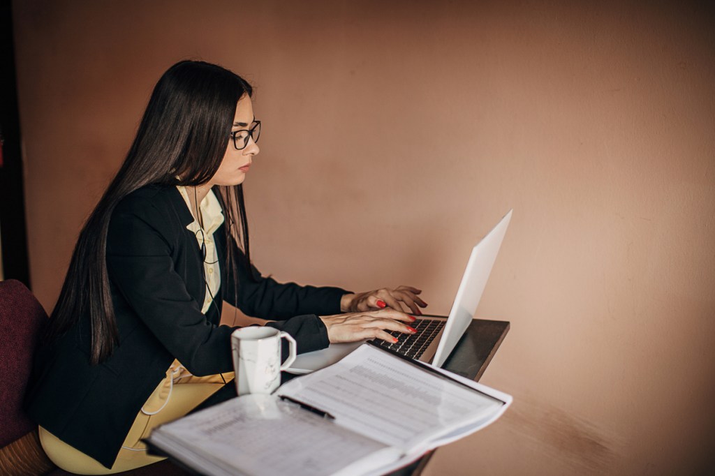 A woman researching strategies to get out of debt after a divorce.
