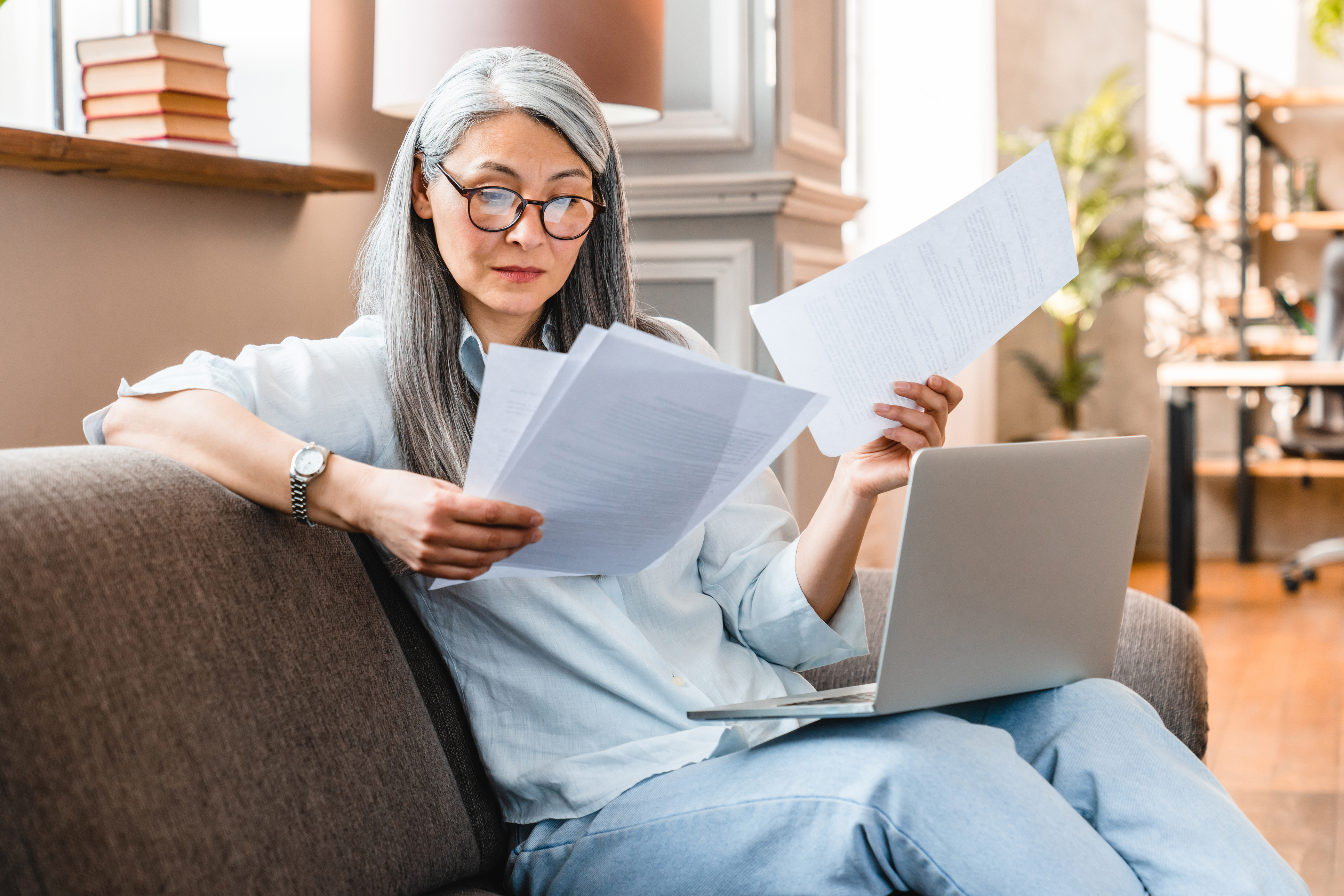 A woman reading paperwork for a real estate offer.