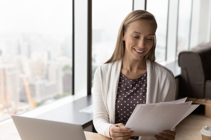 A financial advisor reviewing documents to value a wealth management firm.