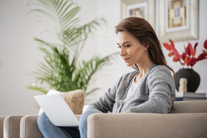 A woman researching how tariffs could impact her investments.