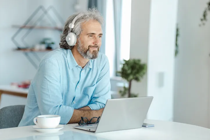 An investor discussing distressed asset investments with a financial advisor on a video meeting.