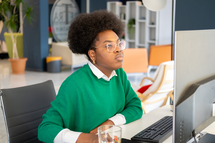 A woman researching how tariffs could hurt consumers.