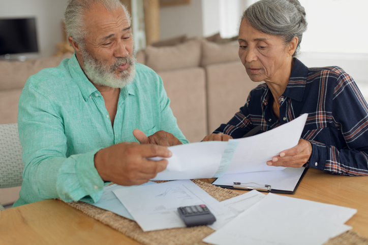 A senior couple reviewing investments in their retirement plan.