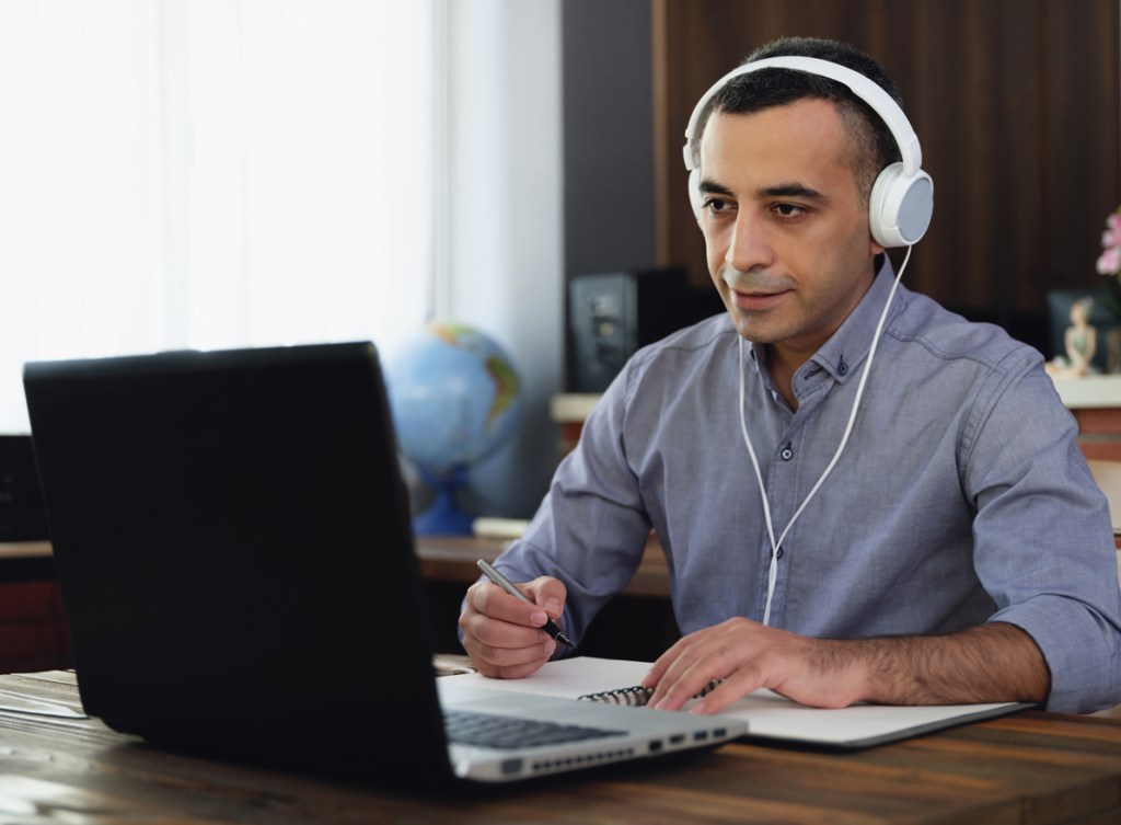 An investor discussing his investment portfolio via video with an advisor.