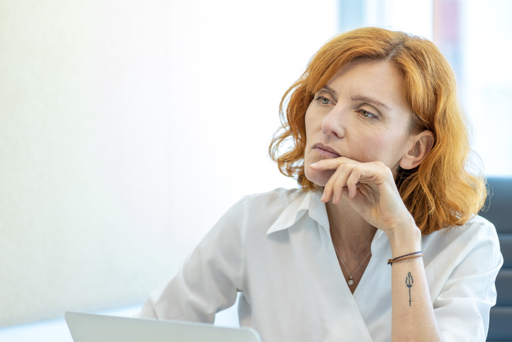 A Gen X woman thinking about working with a financial advisor for her retirement plan.