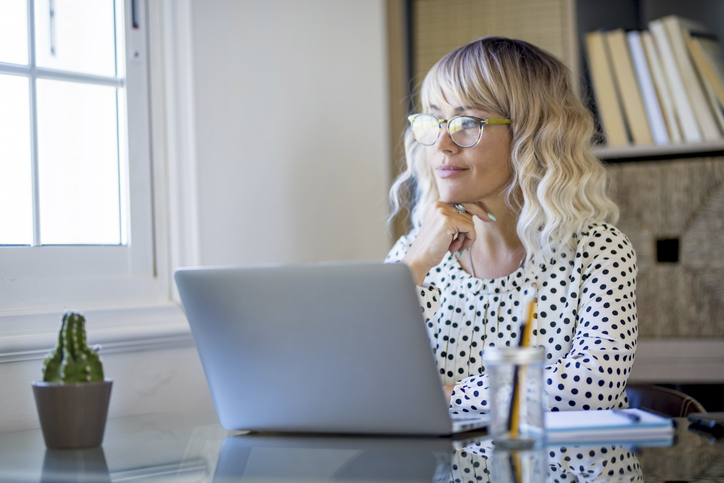 A woman thinking about paying her mortgage early or offsetting it.