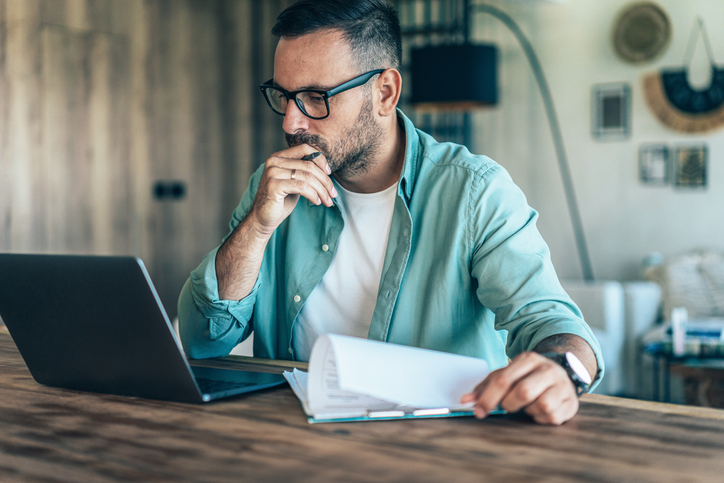 A tax filer reviewing documents to file his taxes.