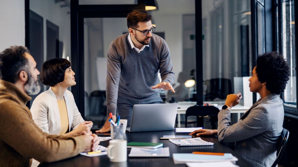 A man gives a presentation in a conference room.