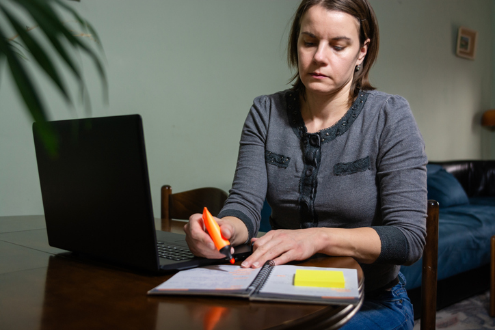 A woman reviewing the key differences between living and revocable trusts.