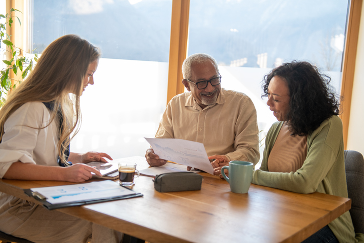 A financial advisor sitting down with new clients.
